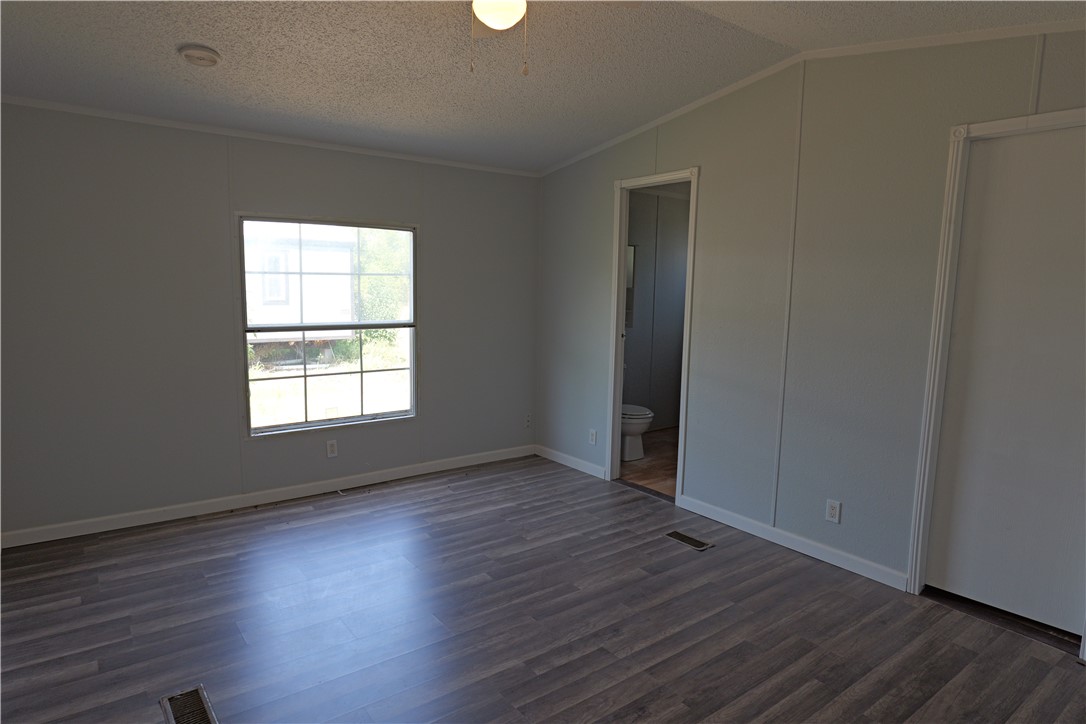 732 B Rogers Street Normangee, TX 77871 - Photo 5 of 9 an empty room with wooden floor and windows