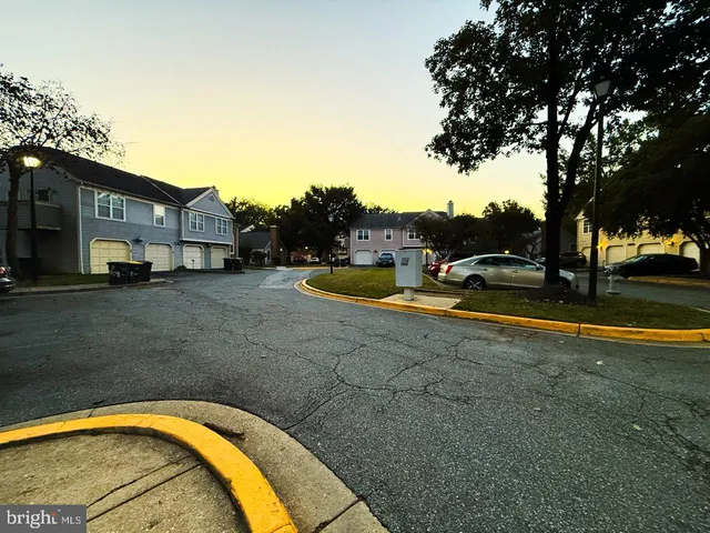 a view of swimming pool with outdoor seating and covered with trees