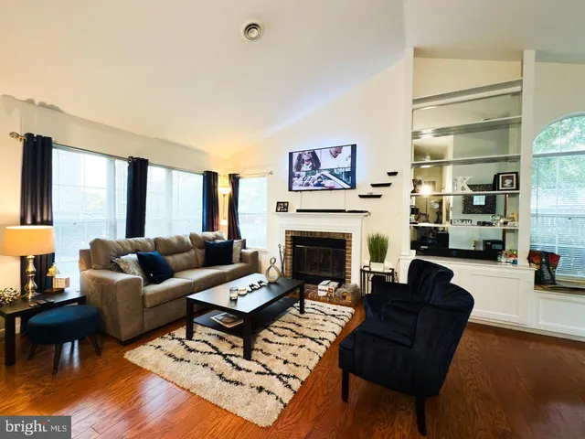 a living room with furniture a fireplace and a table