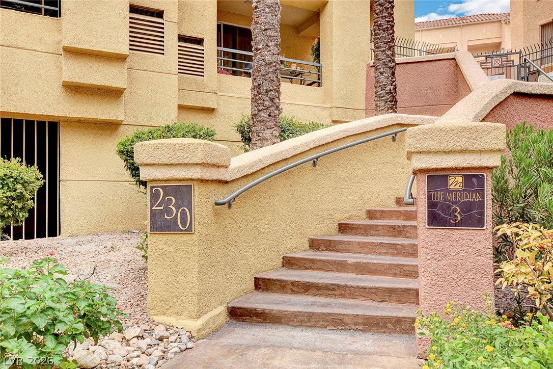 230 East Flamingo Road, Unit 106 Las Vegas, NV 89169 - Photo 27 of 66 An inviting entrance with sturdy steps leads to a multi-story building, surrounded by desert-friendly landscaping.