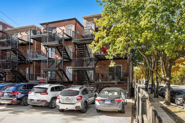 a view of a cars park in front of a building