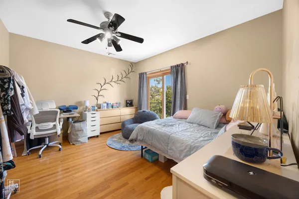 a bedroom with furniture and a wooden floor