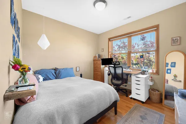 a bedroom with a bed and a large window