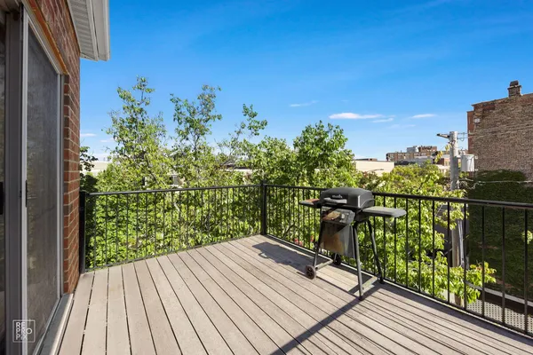 a view of a balcony with wooden floor