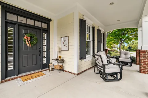 a view of hallway with livingroom and wooden floor