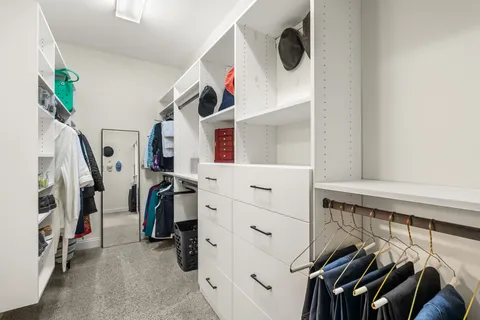 a view of a livingroom with wooden floor and furniture