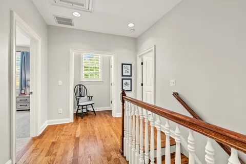 a bedroom with a bed a couch and a chandelier