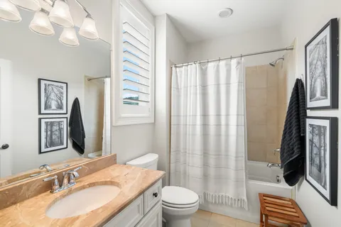 a spacious bedroom with a bed a couch and a window