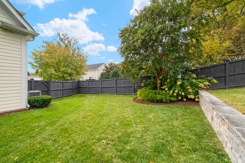 a view of a backyard with a garden and entertaining space