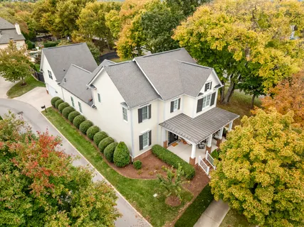 an aerial view of a house with a yard