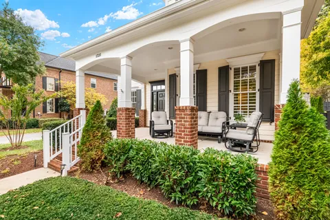a view of a house with sitting area and garden