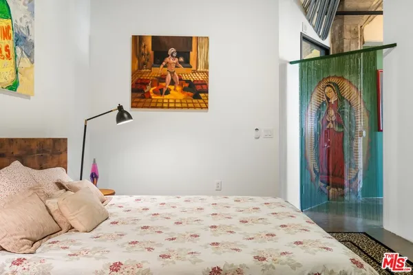 a bedroom with a bed and a walk in closet