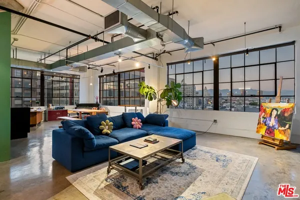 a living room with furniture a rug and a chandelier