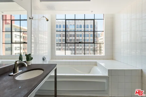 a bathroom with a granite countertop sink a toilet and a bathtub