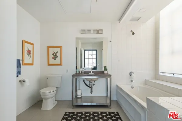 a white toilet sitting next to a bathroom sink