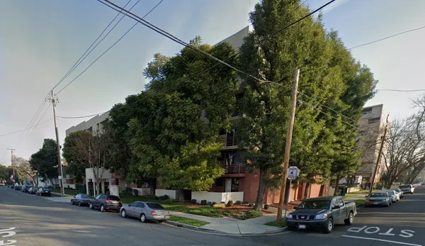 a city street lined with buildings and trees