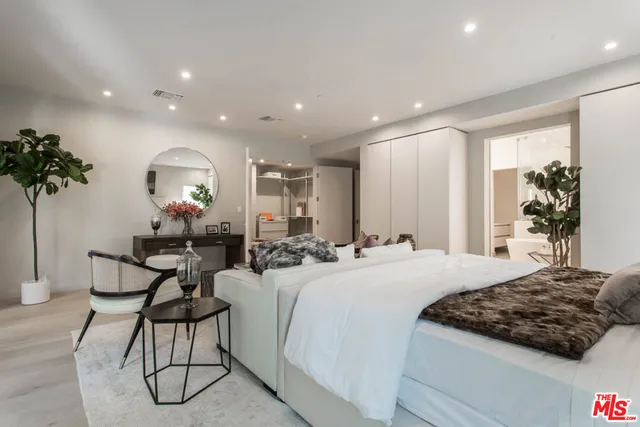 a bedroom with a bed and chandelier