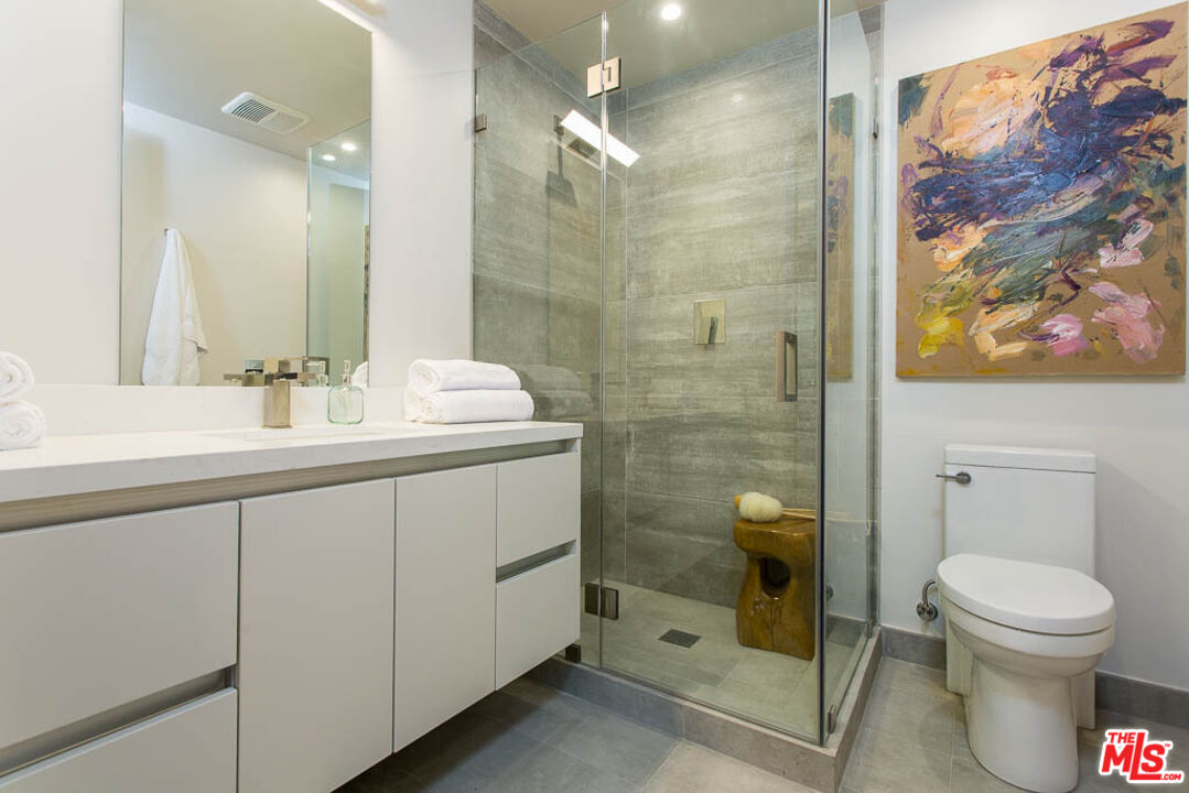1621 Malcolm Avenue, Unit 101 Los Angeles, CA 90024 - Photo 24 of 34 a bathroom with a sink toilet and shower