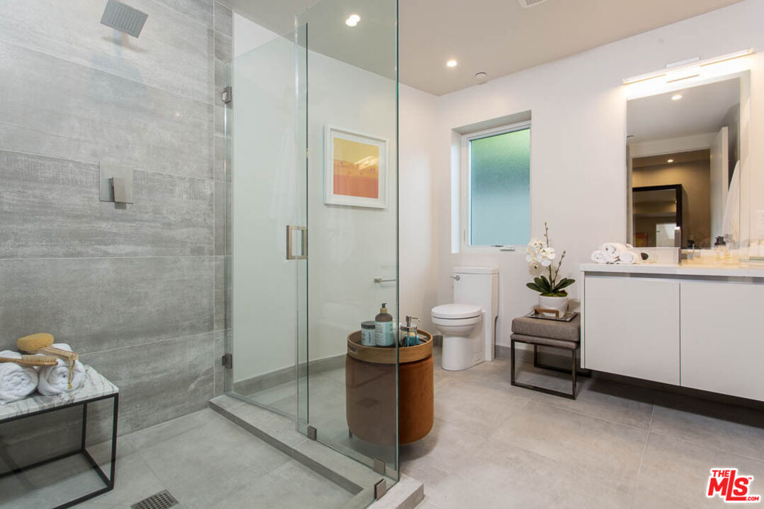 1621 Malcolm Avenue, Unit 101 Los Angeles, CA 90024 - Photo 27 of 34 a bathroom with a sink a toilet and mirror