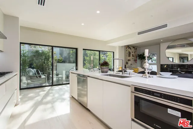 a kitchen with stainless steel appliances sink and stove