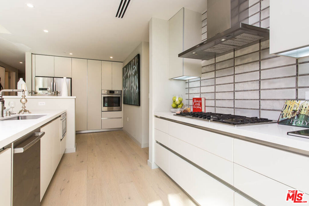 1621 Malcolm Avenue, Unit 101 Los Angeles, CA 90024 - Photo 10 of 34 a kitchen with a sink cabinets and appliances