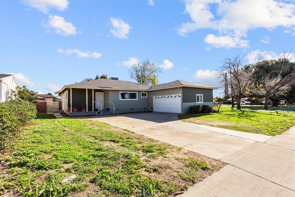 a front view of a house with a yard and a garage