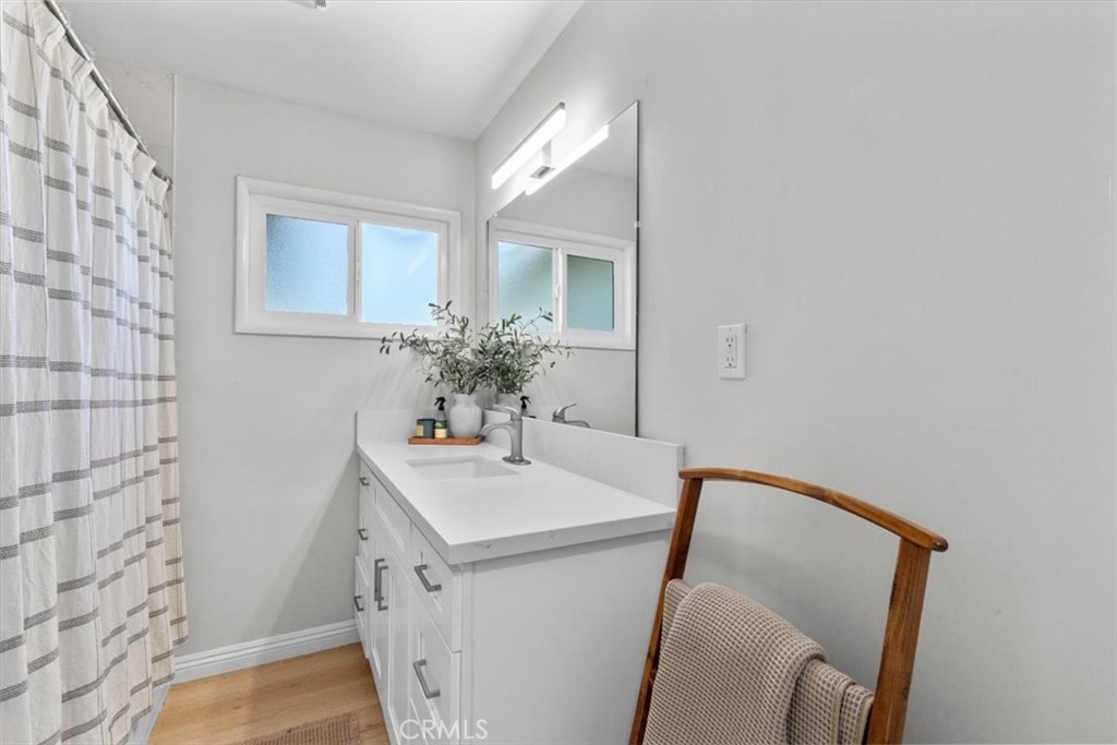 565 North Riverside Avenue Rialto, CA 92376 - Photo 11 of 19 a bathroom with a sink and mirror with toilet