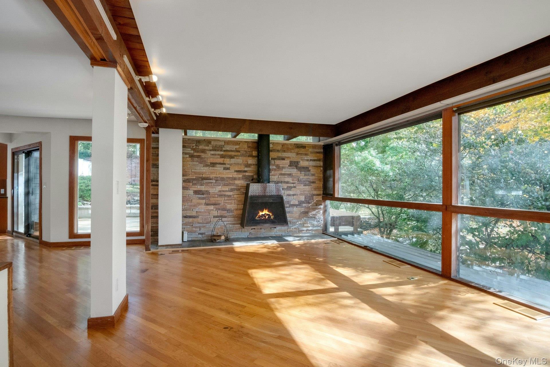 309 Scarborough Road Briarcliff Manor, NY 10510 - Photo 14 of 50 a view of an empty room with wooden floor and a window