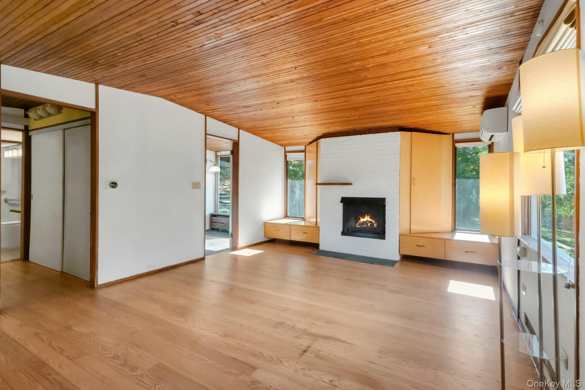 309 Scarborough Road Briarcliff Manor, NY 10510 - Photo 23 of 50 a view of an empty room with a fireplace and a window