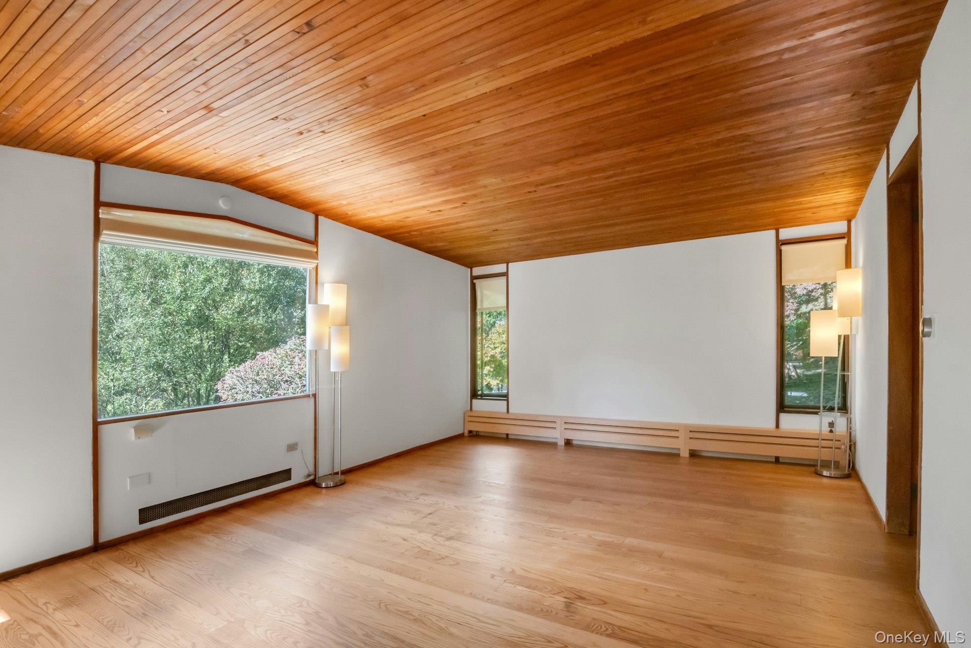 309 Scarborough Road Briarcliff Manor, NY 10510 - Photo 25 of 50 an empty room with wooden floor and windows