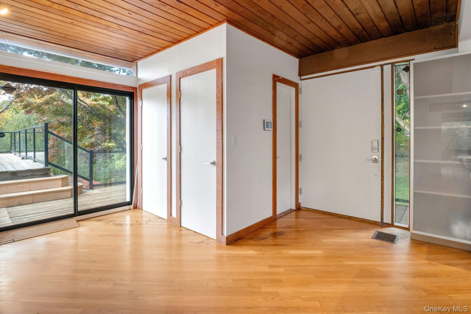 309 Scarborough Road Briarcliff Manor, NY 10510 - Photo 4 of 50 a view of empty room with wooden floor and floor to ceiling window