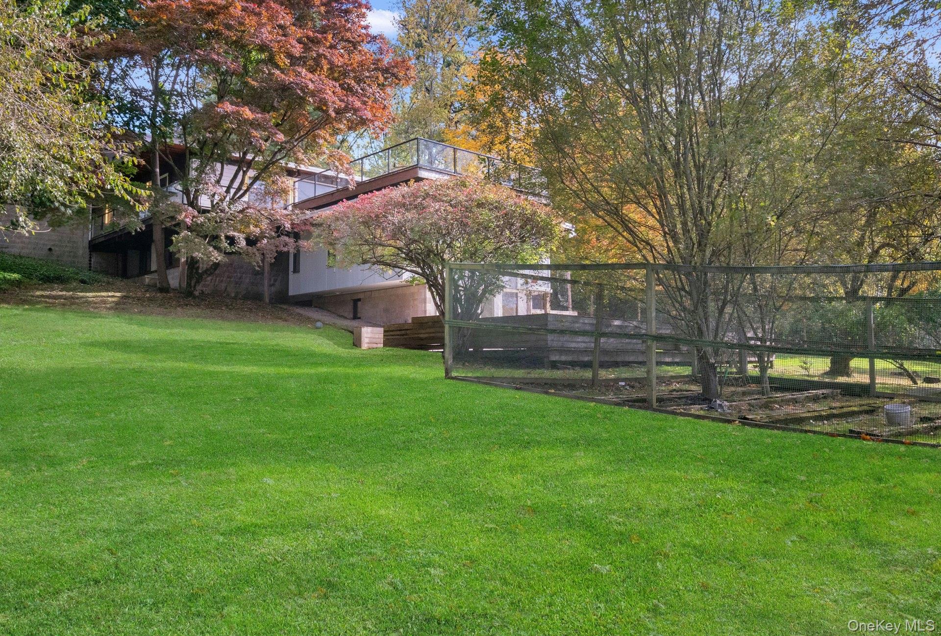 309 Scarborough Road Briarcliff Manor, NY 10510 - Photo 41 of 50 a view of a house with a yard