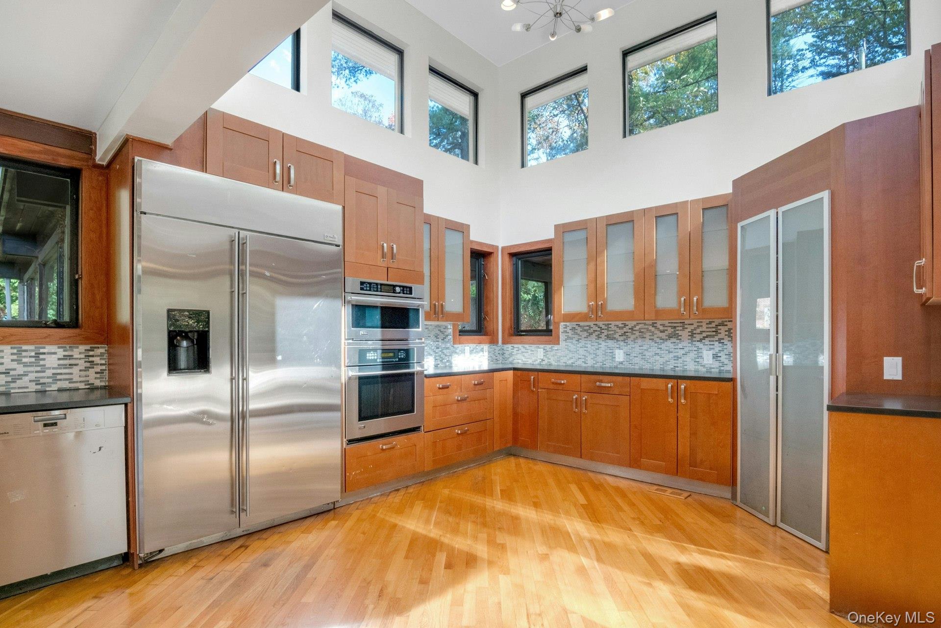 309 Scarborough Road Briarcliff Manor, NY 10510 - Photo 5 of 50 a large kitchen with stainless steel appliances granite countertop a refrigerator and a stove top oven
