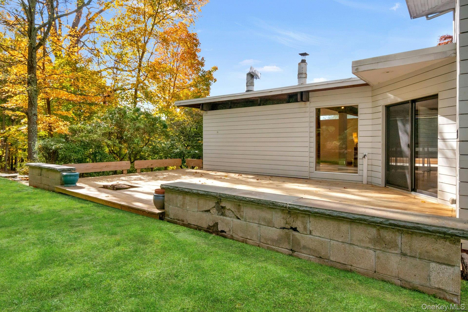 309 Scarborough Road Briarcliff Manor, NY 10510 - Photo 10 of 50 a view of a backyard with a garden and tree
