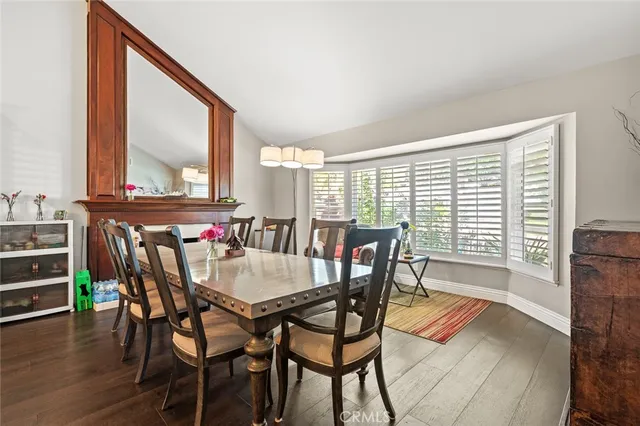a dining room with furniture a fireplace and wooden floor