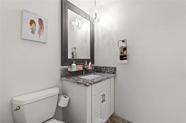 a bedroom with bed a flat tv screen and a bookshelf