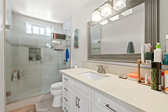 a bedroom with a bed a large window and walk in closet