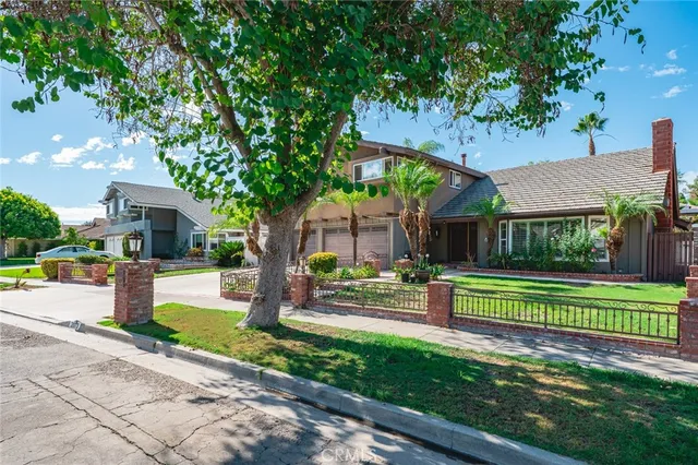a view of a house with swimming pool and sitting area