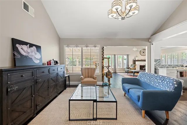 a living room with furniture a flat screen tv and a large window