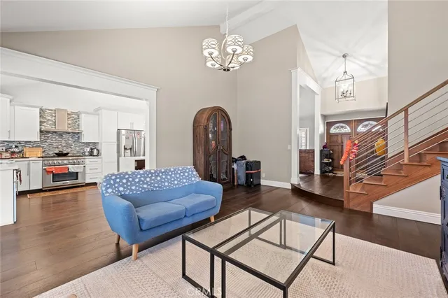 a living room with furniture and a chandelier