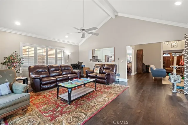 a living room with furniture a rug and a chandelier