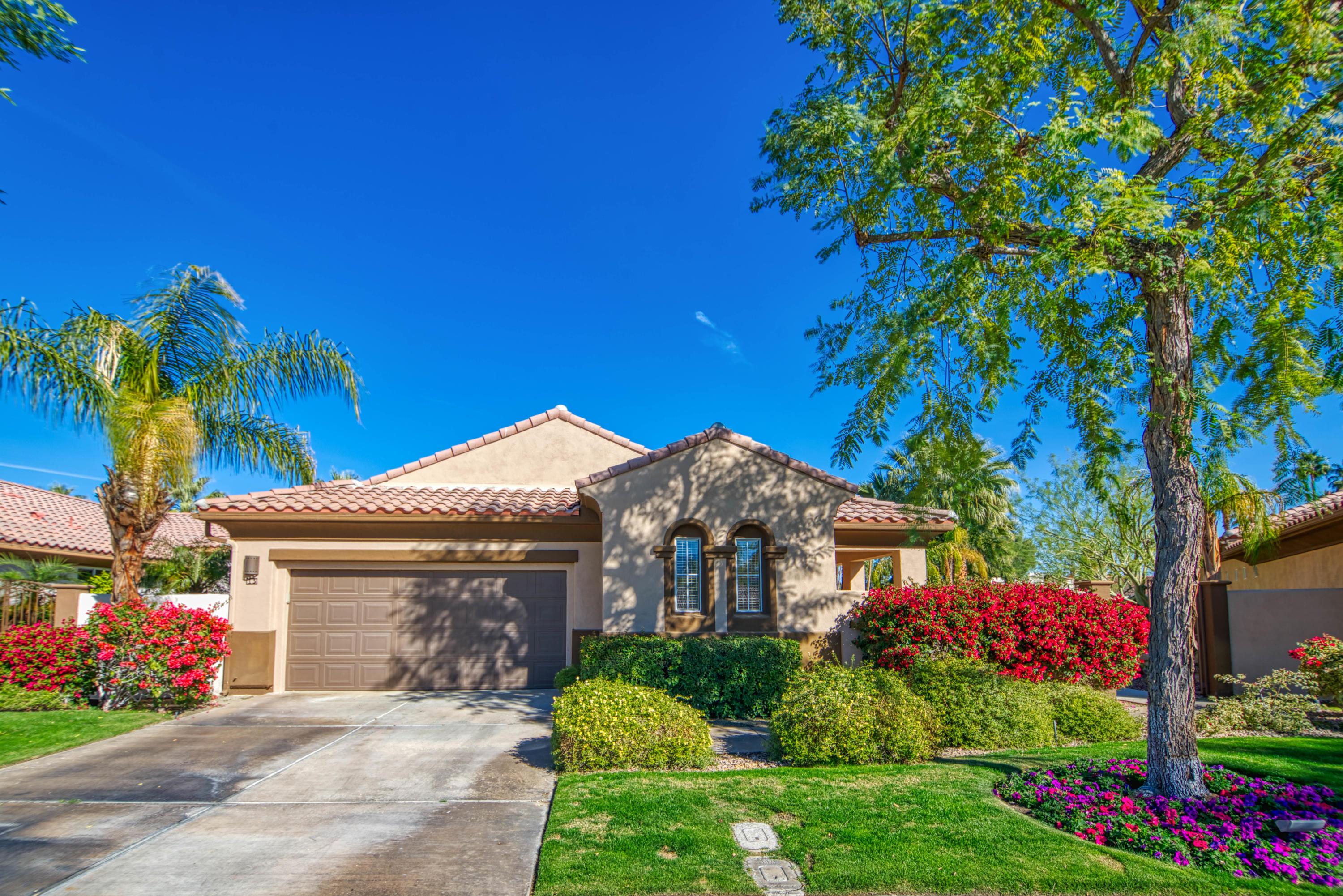 13 Wimbledon Circle Rancho Mirage, CA 92270 - Photo 17 of 62 a front view of a house with a yard