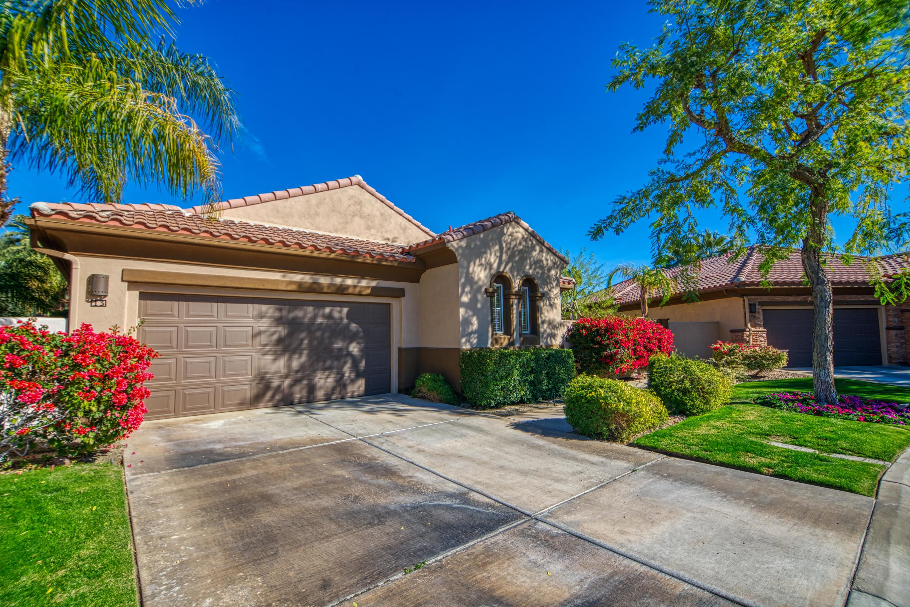 13 Wimbledon Circle Rancho Mirage, CA 92270 - Photo 18 of 62 a front view of a house with a garden
