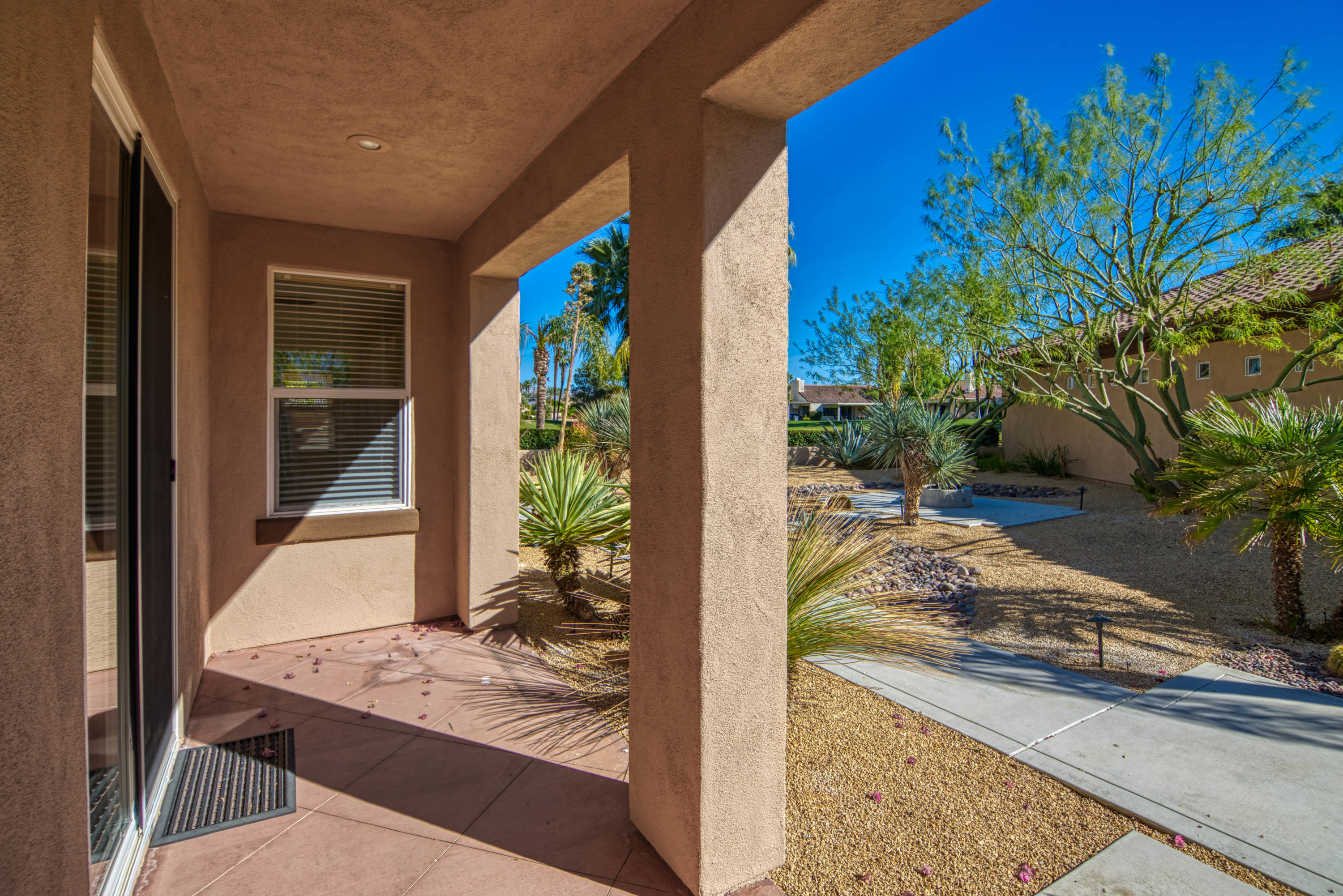 13 Wimbledon Circle Rancho Mirage, CA 92270 - Photo 20 of 62 a view of a porch with furniture and floor to ceiling window