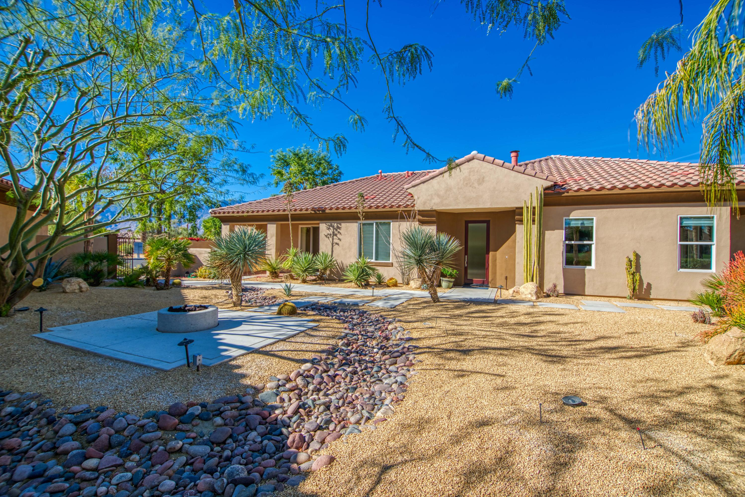 13 Wimbledon Circle Rancho Mirage, CA 92270 - Photo 23 of 62 a front view of a house with garden