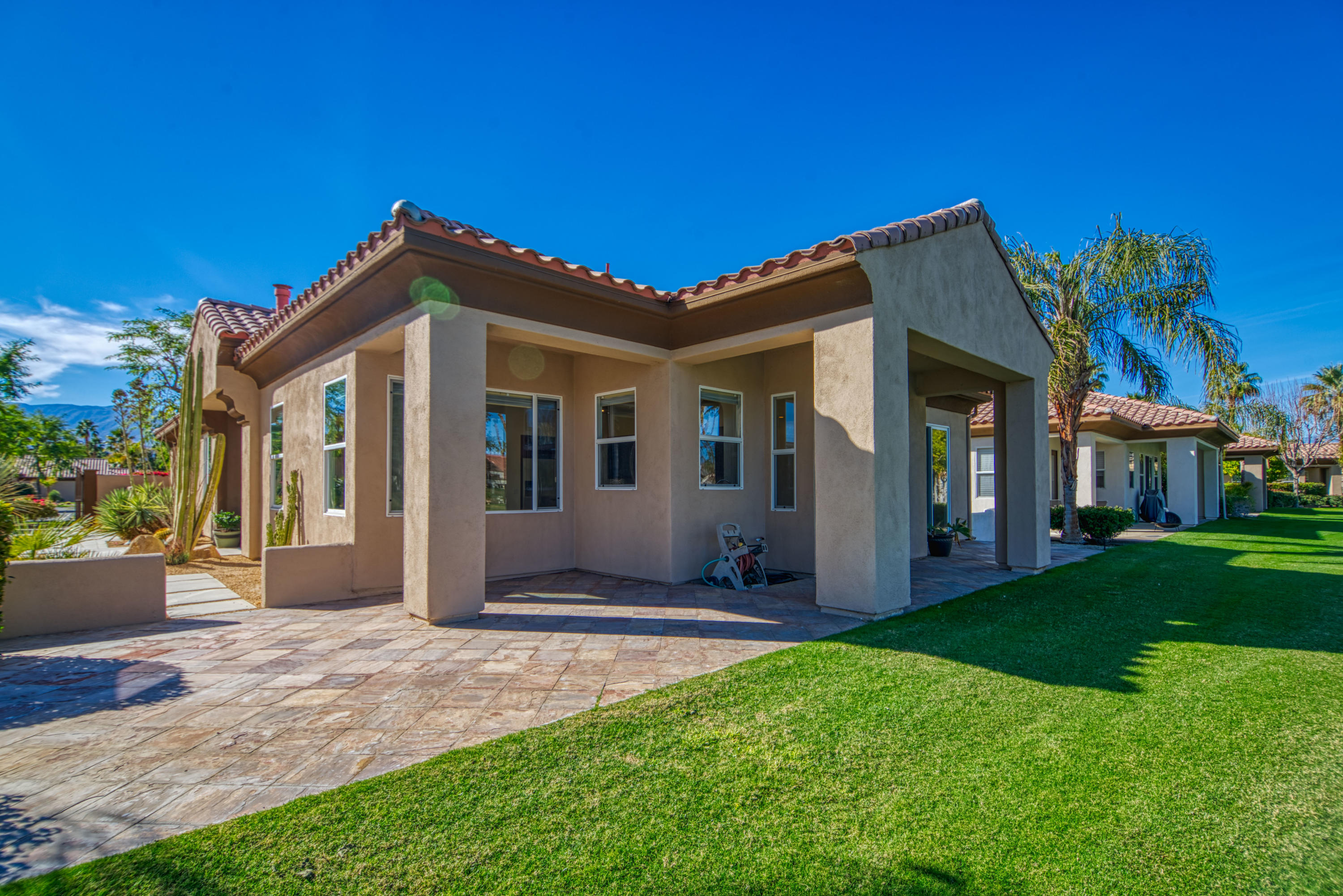 13 Wimbledon Circle Rancho Mirage, CA 92270 - Photo 25 of 62 a front view of a house with a yard