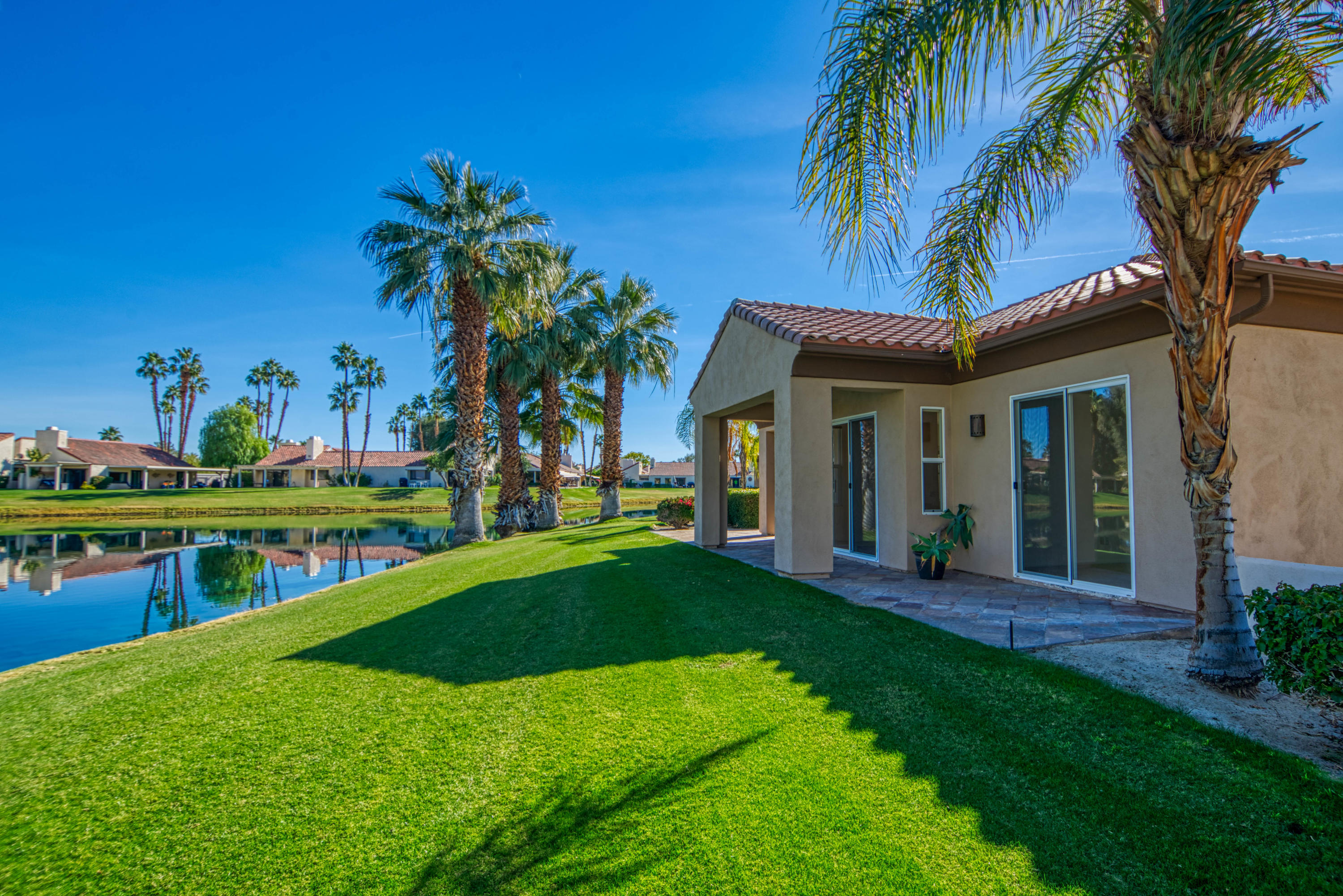 13 Wimbledon Circle Rancho Mirage, CA 92270 - Photo 26 of 62 a view of a house with swimming pool and a yard