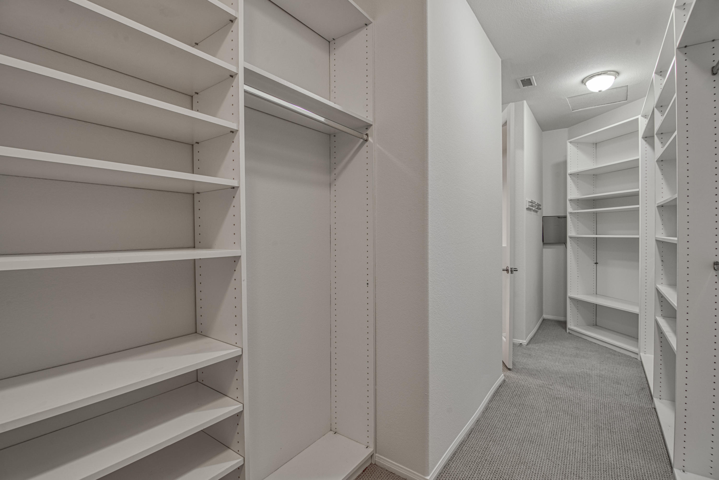 13 Wimbledon Circle Rancho Mirage, CA 92270 - Photo 43 of 62 a view of walk in closet with empty racks