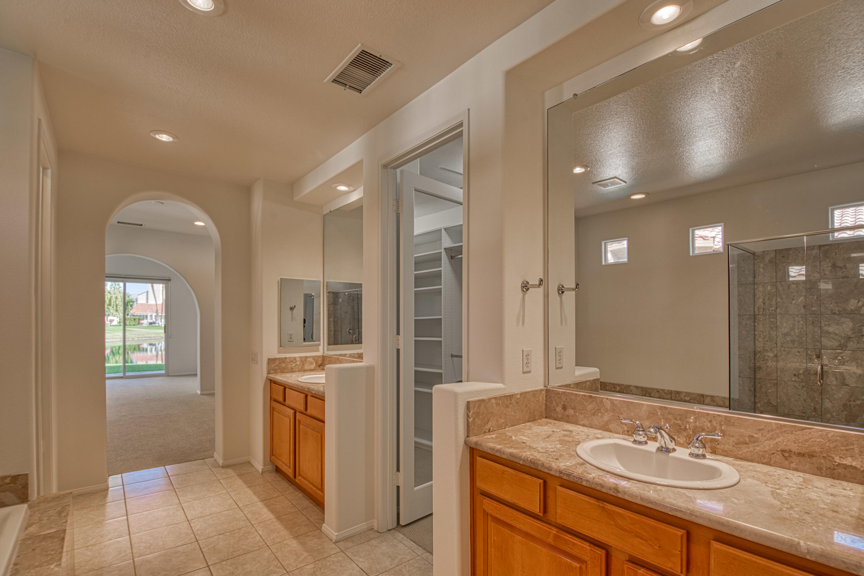 13 Wimbledon Circle Rancho Mirage, CA 92270 - Photo 45 of 62 a bathroom with a sink double vanity and a mirror