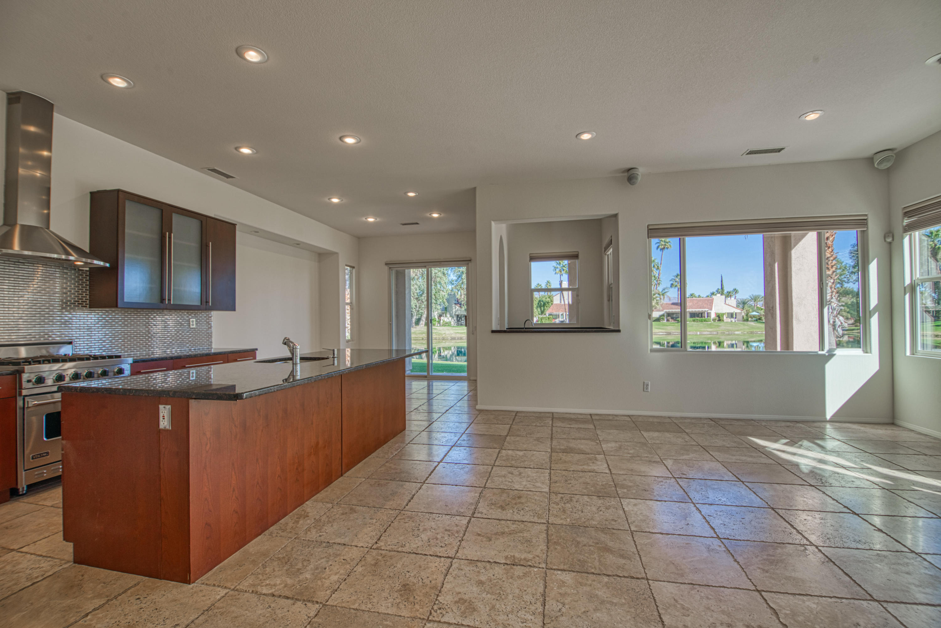 13 Wimbledon Circle Rancho Mirage, CA 92270 - Photo 53 of 62 a large kitchen with stainless steel appliances granite countertop a large counter top and a stove top oven